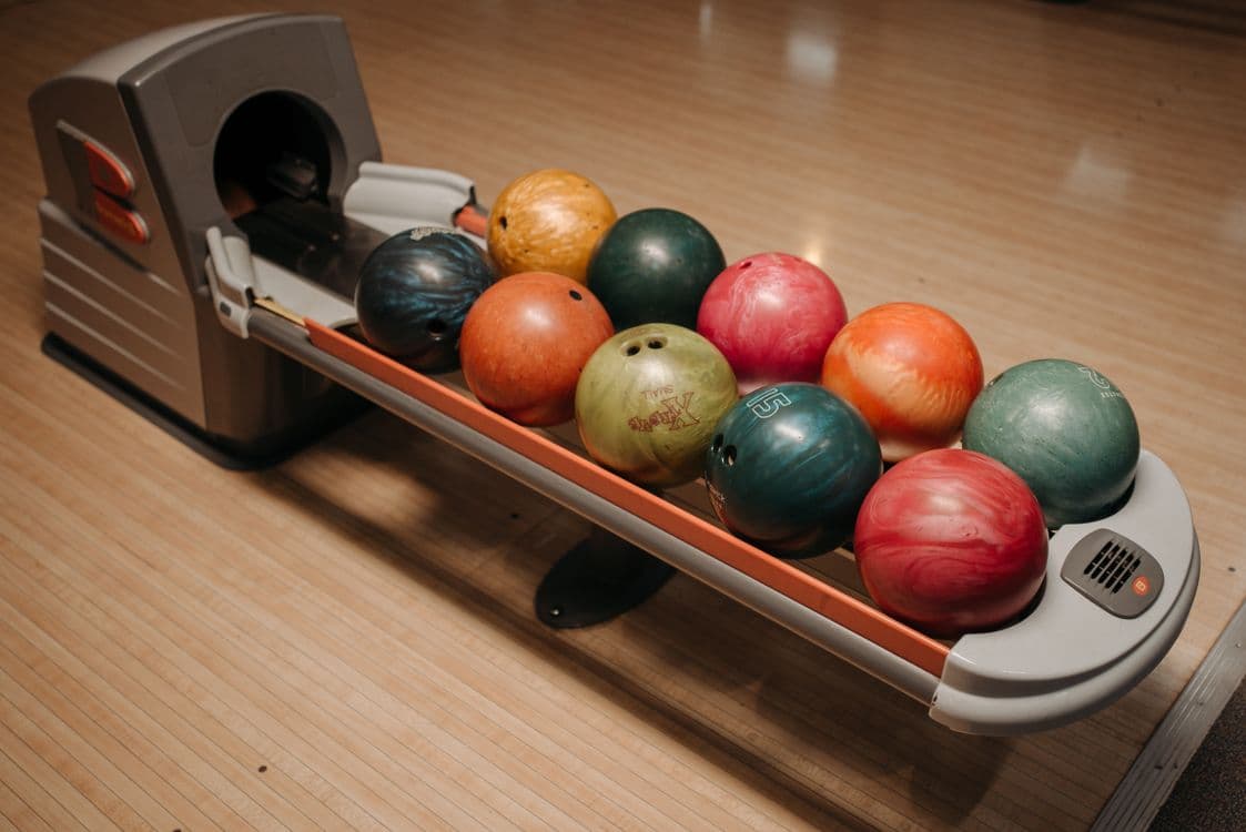 Colorful bowling balls on the return
